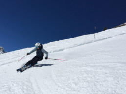 Julia skiing the spring snow on piste