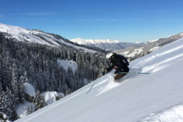 An off piste skier skiing powder in Moriond