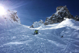 Skier skiing off piste in a Courchevel couloir